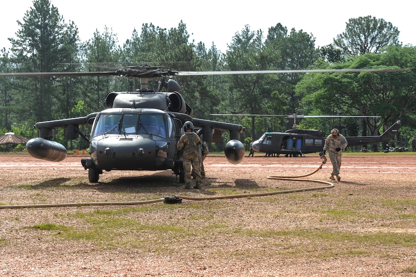 U.S. Army Spec. Rashan Gaskin, 1st Battalion, 228th Aviation Regiment fuel technician, finishes refueling a UH-60 Black Hawk during the twentieth iteration of Operation CARAVANA, in Mocorón, Honduras, June 9, 2016. The successful movement of Honduran troops to their outposts is the most visible part of this multi-layer operation. However, CARAVANA operations would not happen without the support and Tactical Air Command teams staged at Mocorón and Puerto Castilla - which consist of fuel technicians, mechanics, weather forecasters, communication specialists, medics and a medical evacuation crew. (U.S. Air Force photo by Staff Sgt. Siuta B. Ika)
