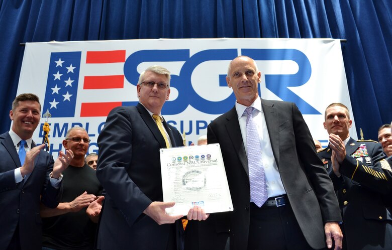With an audience of civilian and military supporters, Employer Support of the Guard and Reserve Director Alex Baird, left, and the President and CEO of Comcast Cable and Senior Executive Vice President of Comcast Corp. Neil Smit sign the ESGR Statement of Support in Philadelphia, June 14, 2016. Among the four pledges assigned to the support statement is a continual recognition and support for the country’s service members and their families in peace, crises and war. (U.S. Air National Guard photo by Tech. Sgt. Andria Allmond)
