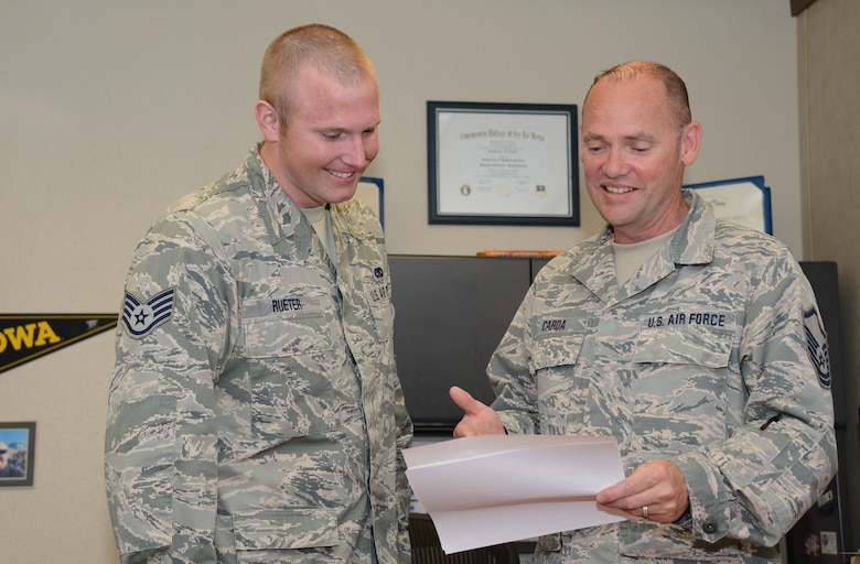 185th Air Refueling Wing, Iowa Air National Guard base education and training manager Master Sgt. Larry Carda looks at a Community College of the Air Force progress report with Staff Sgt. Wes Rueter in Sioux City, Iowa on June 16, 2016. The Community College of the Air Force ranked the Iowa Air National Guard number one in CCAF degrees awarded in the past year.
(U.S. Air National Guard photo by Master Sgt. Vincent De Groot)