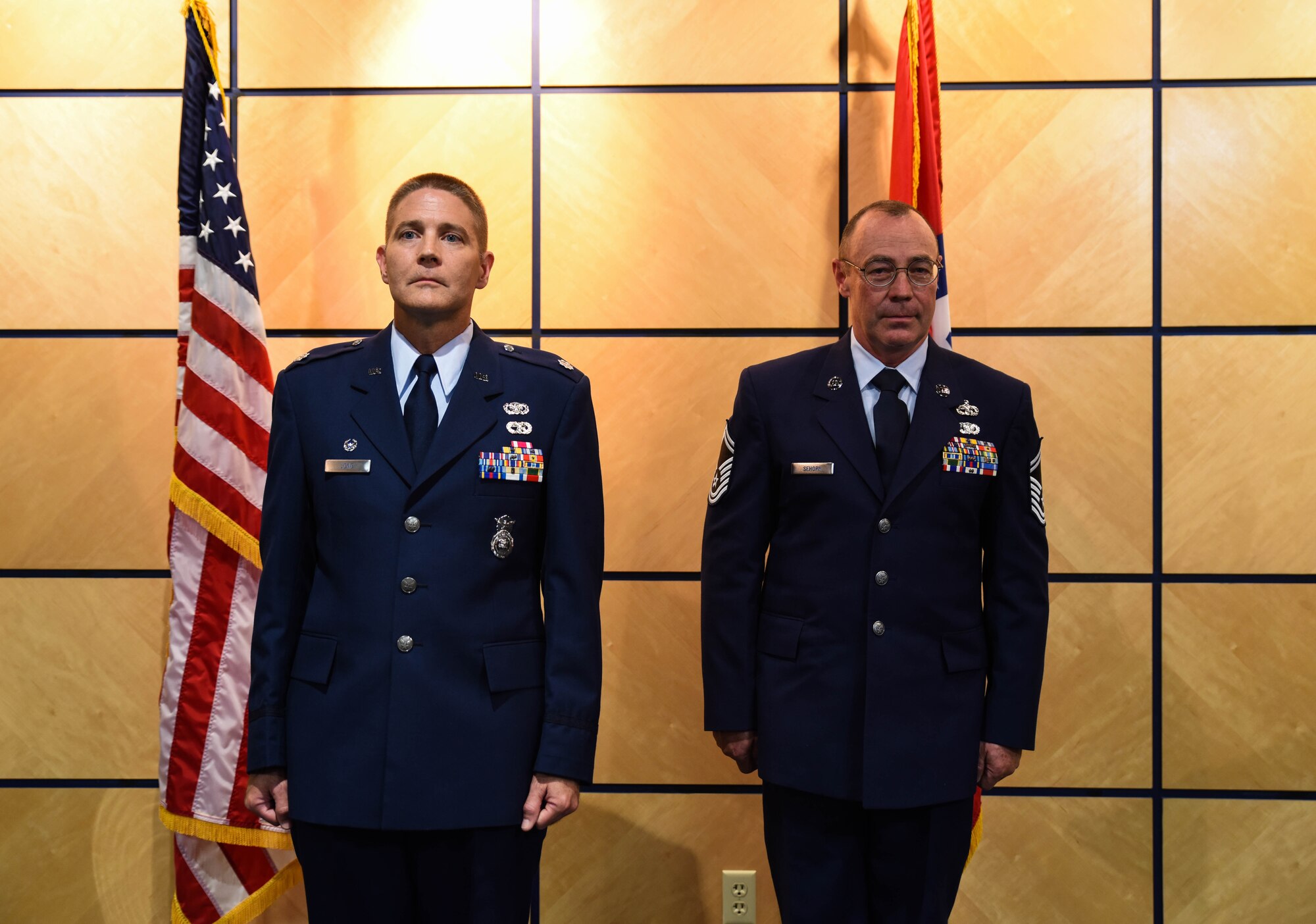 Lt. Col. Mitch Long, 188th Mission Support Group deputy commander, and Chief Master Sgt. Ricky Sehorn, chief of transportation, stand at attention for orders to promote Sehorn to chief master sergeant at a ceremony June 4, 2016, at Ebbing Air National Guard Base, Fort Smith, Ark. Sehorn has served in vehicle maintenance for the past 24 years and has been chief of transportation since 2014. (U.S. Air National Guard photo by Senior Airman Cody Martin/Released)