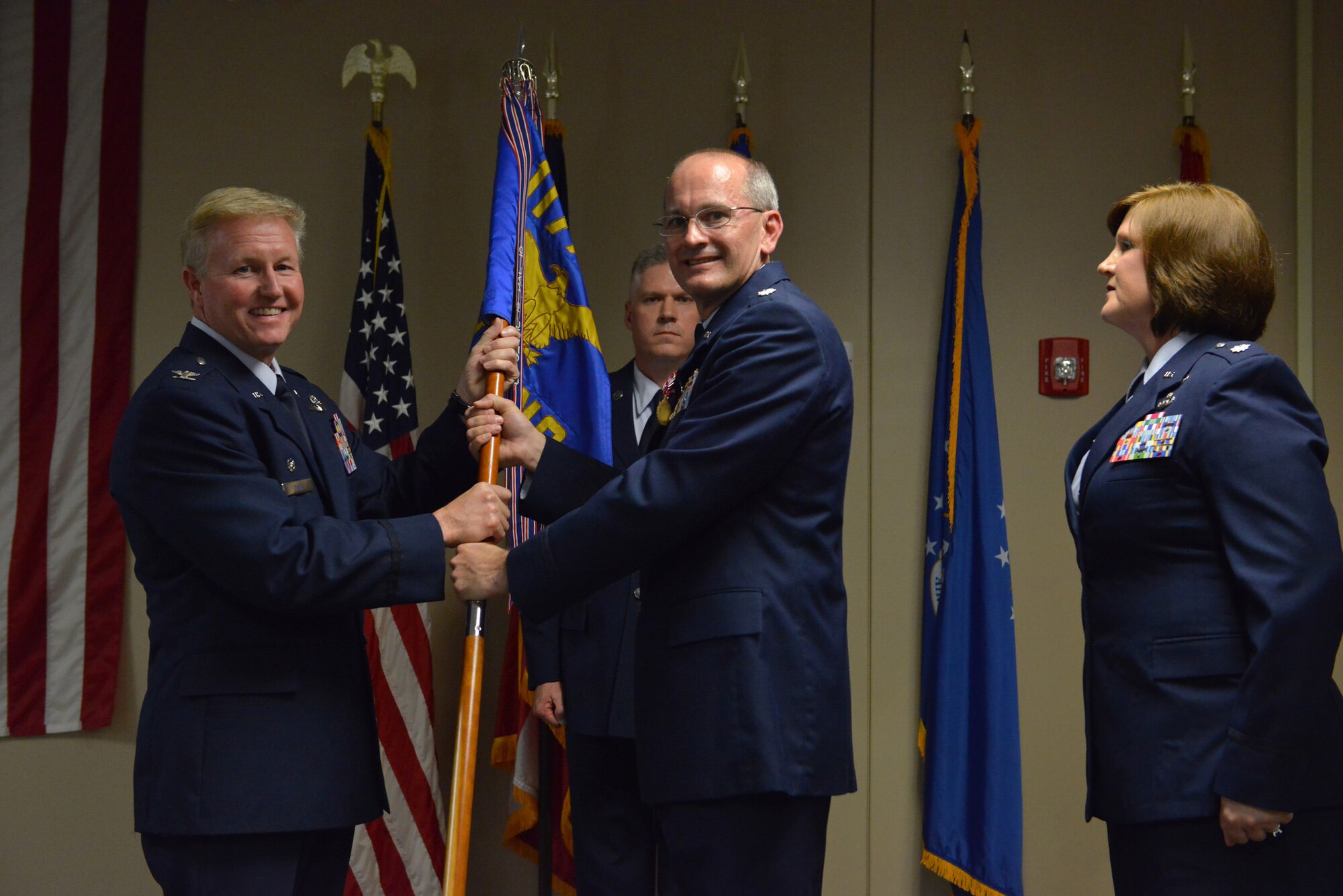 U.S. Air Force Col. Hal Davis the Operations Group commander holds the 117th  Air Control Squadron with Lt. Col. Ronald Speir during a change of Command Ceremony at the 117th Air Control Squadron and Hunter Army Airfield, Ga., June 10, 2016. Speir relinquished command of the 117 ACS and will be taking a new position at the Joint Force Readiness Center in Atlanta, Ga. (U.S. Air National Guard photo by Tech. Sgt. Amber Williams/Released)