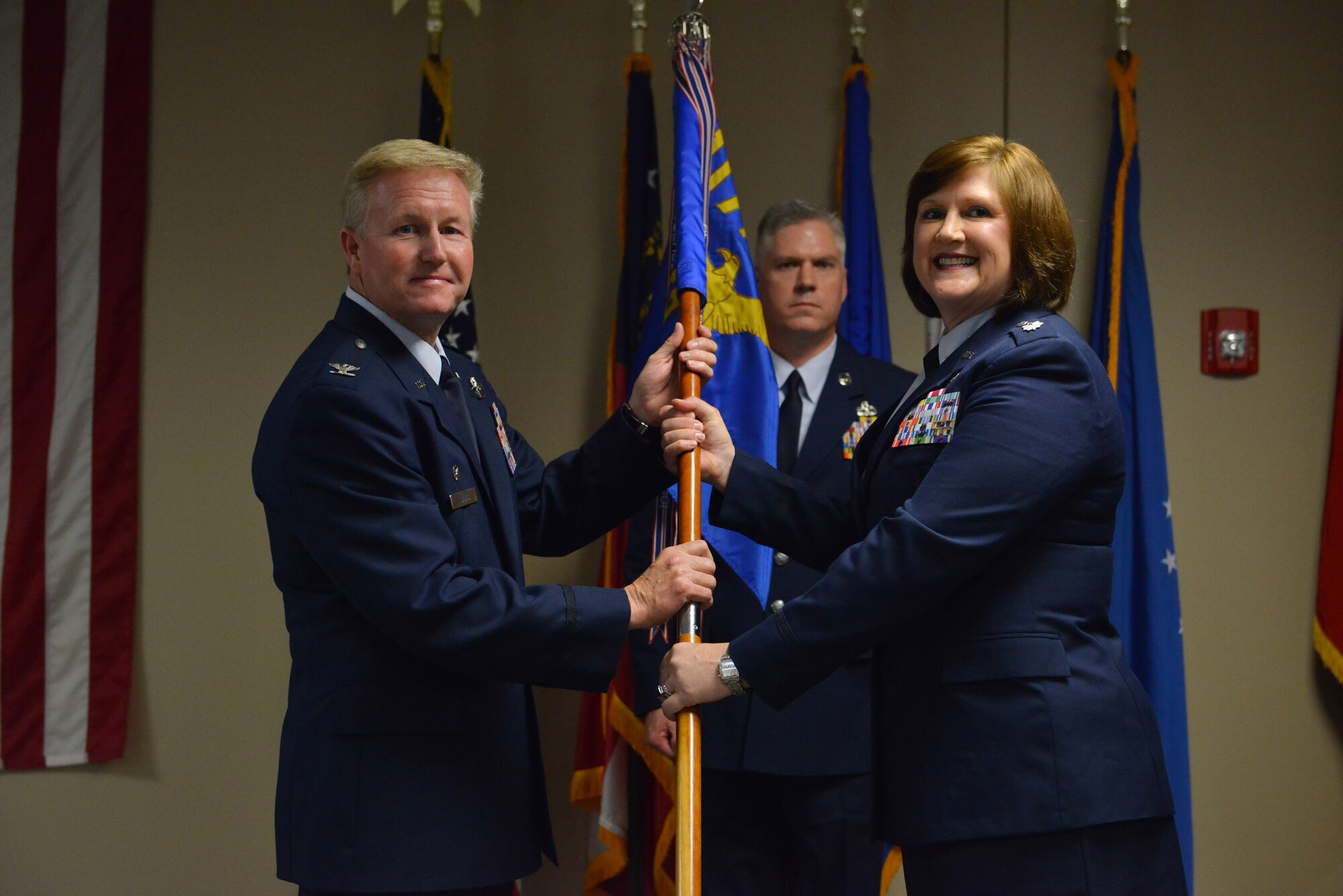U.S. Air Force Col. Hal Davis the Operations Group commander holds the 117th  Air Control Squadron with Lt. Col. Elizabeth Baker during a change of Command Ceremony at the 117th Air Control Squadron and Hunter Army Airfield, Ga., June 10, 2016. (U.S. Air National Guard photo by Tech. Sgt. Amber Williams/Released)
