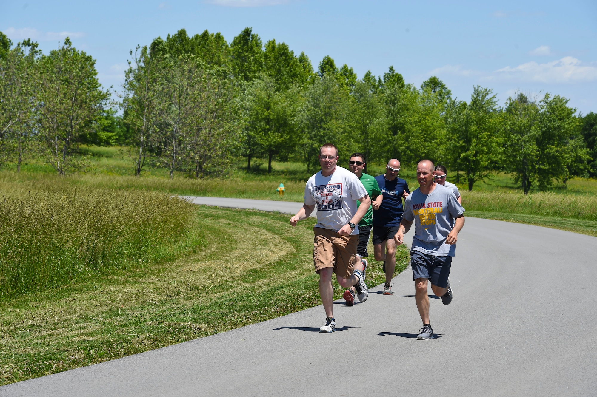 132nd Intelligence Surveillance and Reconnaissance Group members run down a road June 6, 2016, at Moffitt Resevior Park in Cumming, Iowa. The ISRG held an amazing race event to kickstart Annual Training Week. (U.S. Air National Guard photo by Staff Sgt. Michael J. Kelly/Released)