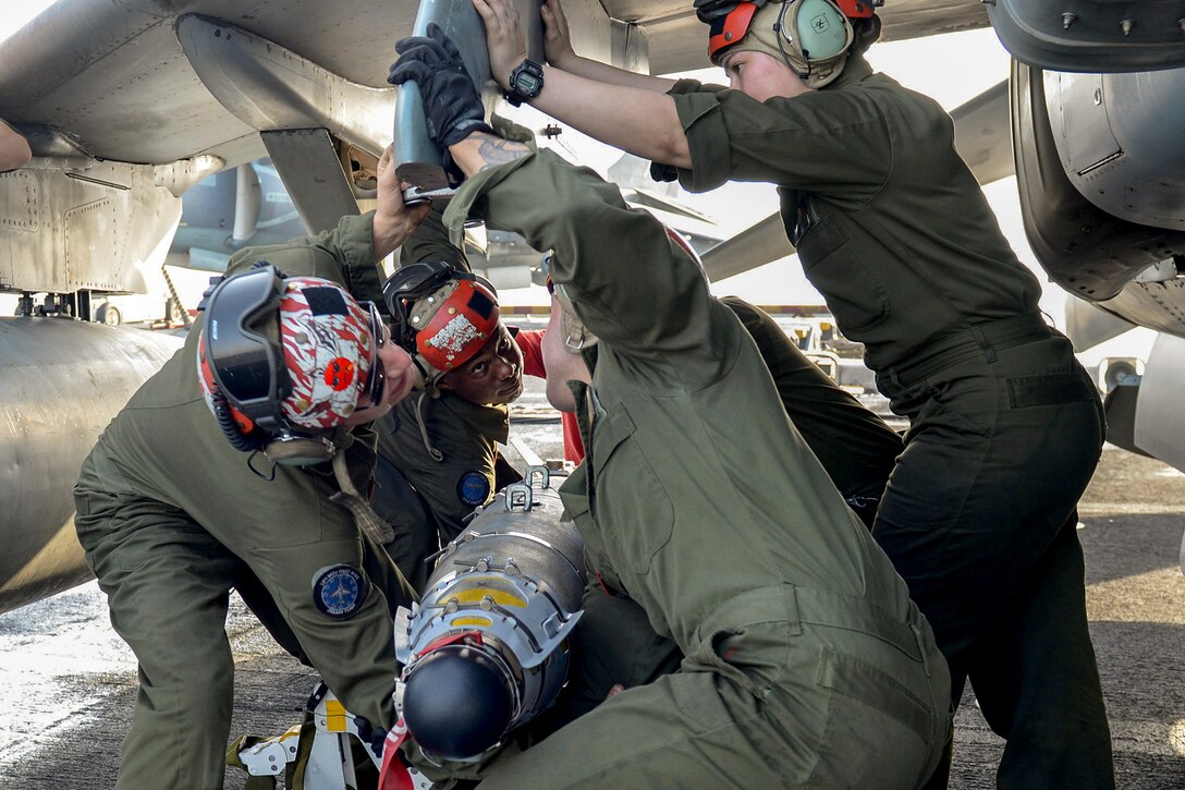 Marines load ordnance onto an AV-8B Harrier II aboard the USS Boxer in the Arabian Gulf, June 16, 2016. The Boxer is supporting security efforts in the U.S. 5th Fleet area of responsibility. Navy photo by Petty Officer 1st Class Brian Caracci