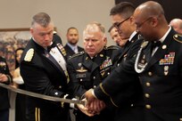 The Army’s birthday was observed with a cake-cutting ceremony by the youngest Soldier present (Pfc. Giovani Hernandez - 3rd person) and by the oldest (Master Sgt. Steven Peters - 2nd person), assisted by 76th ORC Commander, Maj. Gen. Ricky L. Waddell (1st person) and Command Sgt. Maj. Michael J. Robinson (4th person), during the 76th ORC's Utah Army Ball, June 11, at the Living Planet Aquarium, Salt Lake City.