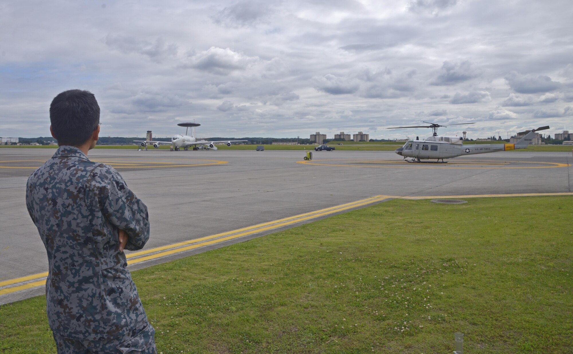 Capt. Naoki Nishino, Japan Air Self-Defense Force weather station forecaster, looks on the flight line during a shadow program with the 374th Operations Support Squadron weather flight at Yokota Air Base, Japan, June 14, 2016. The program enables members from both services to exchange information to gain knowledge on how their counterparts perform their respective jobs. (U.S. Air Force photo by Senior Airman David Owsianka/Released)