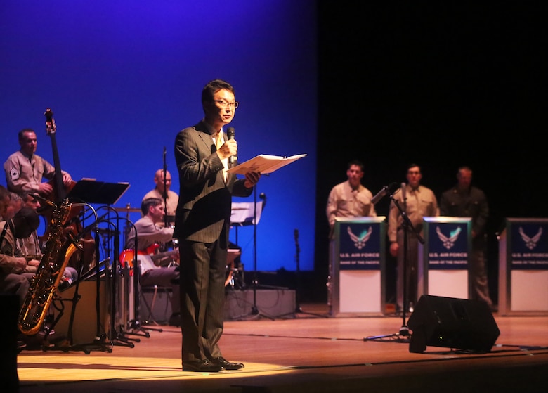Masato Yagi. community relations specialist gives opening remarks to the audience before U.S. Airmen with the U.S. Air Force Band of the Pacific-Asia Showcase jazz ensemble perform at the Iwakuni Civic Hall in Iwakuni, Japan, June 16, 2016. The band of the Pacific-Asia consists of 24 active-duty professional musicians who showcase their talents throughout the Western-Pacific region in support of military and community relations objectives. Based out of Yokota Air Base, Japan, The Pacific Air Force band was established as the United States Air Force Band of the Pacific at Eglin Field, Florida, in 1941. It is one of 12 U.S. Air Force bands, to include the 15-member detachment group stationed at Joint Base Pearl Harbor-Hickam, Hawaii. Pacific Trends and other protocol groups also perform with the Pacific Air Force band and give an average of 200 performances a year for over 125,000 people. 
Hong Kong, Burma, Guam, Singapore, India, Mongolia, Malaysia, Australia, Thailand, Taiwan, the Philippines, Laos, Korea and Japan are some of the past locations the airmen have performed at for military personnel and foreign communities.
