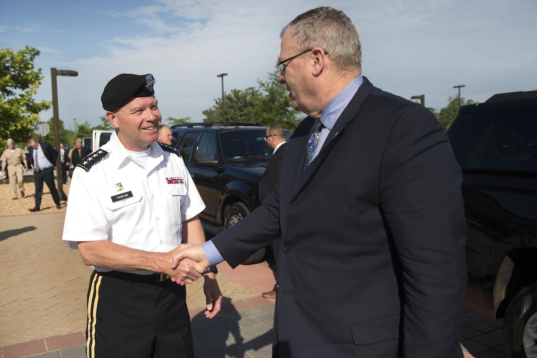 Deputy Defense Secretary Bob Work, right, is greeted by Army Gen. David Perkins, commander, U.S. Army Training and Doctrine Command, upon his arrival at Fort Eustis, Va., June 16, 2016. DoD photo by Navy Petty Officer 1st Class Tim D. Godbee