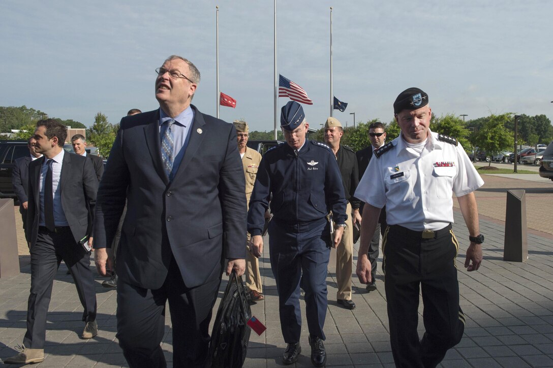 Deputy Defense Secretary Bob Work, left, Air Force Gen. Paul J. Selva, vice chairman of the Joint Chiefs of Staff, center, and Army Gen. David Perkins, commander, U.S. Army Training and Doctrine Command, enter the headquarters building at Fort Eustis, Va., June 16, 2016. DoD photo by Navy Petty Officer 1st Class Tim D. Godbee