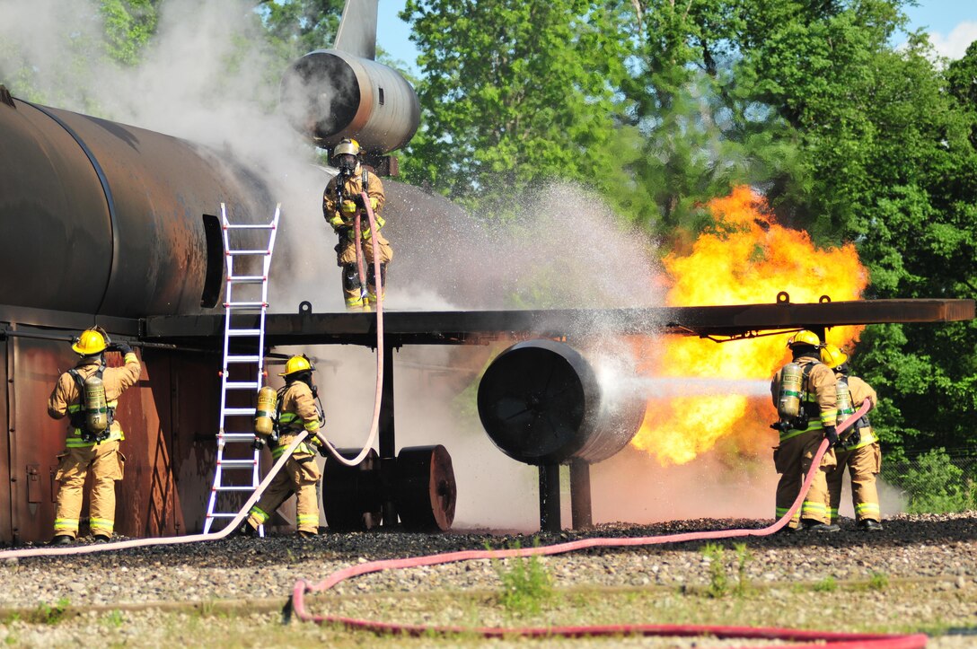 Pennsylvania Air National Guardsmen with the 171st Air Refueling Wing's Fire Protection Flight participate in an annual training exercise at the Pittsburgh International Airport’s Air Rescue and Firefighting facility June 7, 2016. The exercise simulated an aircraft crash, burn and rescue procedures. (Air National Guard photo/Staff Sgt. Allyson L. Manners)