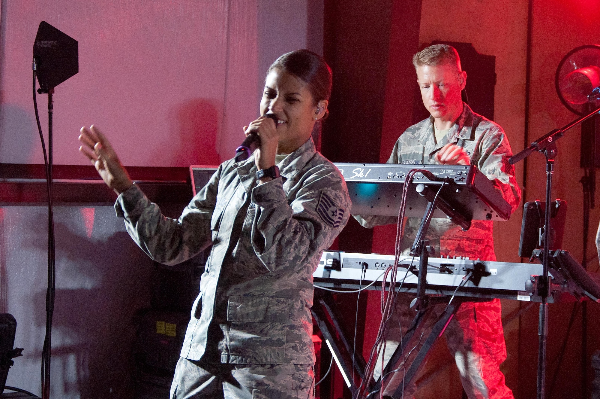 Tech. Sgt. Nalani Quintello, a vocalist with the Air Force Central Command band, "Maximum Impact", performs for the troops at an undisclosed location June 12, 2016. The band opened for comedian, Sinbad who toured several bases to perform to help boost morale to deployed members around the theater.(U.S. Air Force photo by Master Sgt. Anika Jones/Released)