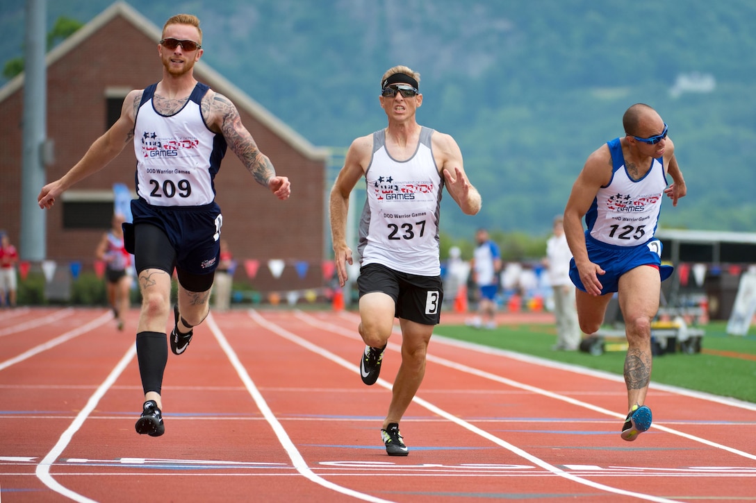From left, Navy Petty Officer 2nd Class Matthew Jameson Estes, Army Lt. Col. David O’Hearn of the U.S. Special Operations Command team and Air Force Staff Sgt. Charles W. Ming finish first, second and third, respectively, in a men’s 200-meter race during the 2016 Department of Defense Warrior Games at the U.S. Military Academy in West Point, N.Y., June 16, 2016. DoD photo by EJ Hersom