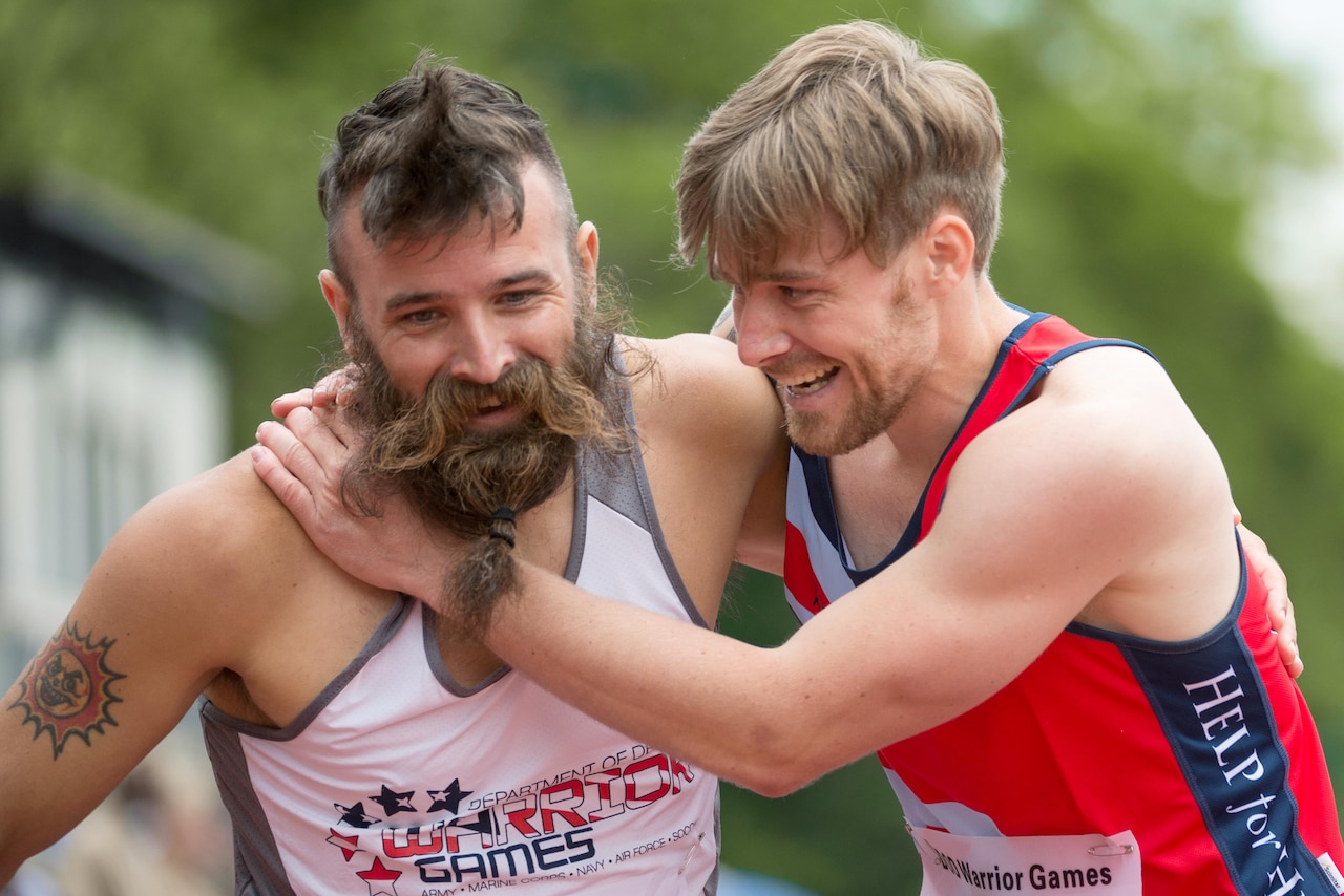 Army veteran Fred Lewis, left, a member of the U.S. Special Operations Command team, and U.K. team member Corbin Mackin, a British army veteran, react to finishing a men’s 200-meter race together during the 2016 Department of Defense Warrior Games at the U.S. Military Academy in West Point, N.Y., June 16, 2016. DoD photo by EJ Hersom