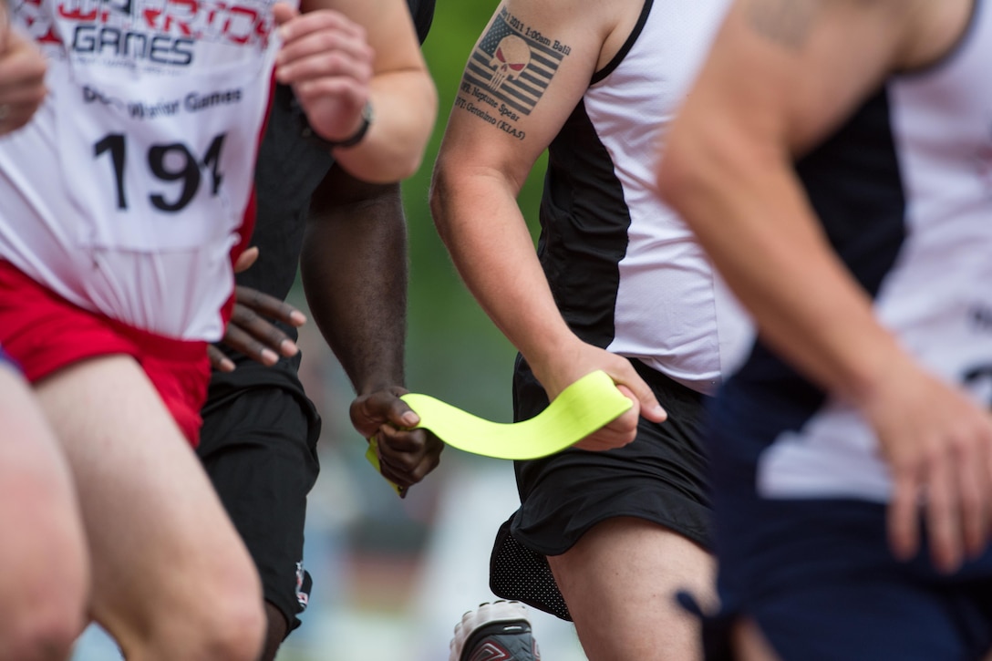 A ribbon tethers a visually impaired runner with his guide during an 800-meter race as part of the 2016 Department of Defense Warrior Games at the U.S. Military Academy in West Point, N.Y., June 16, 2016. DoD photo by EJ Hersom