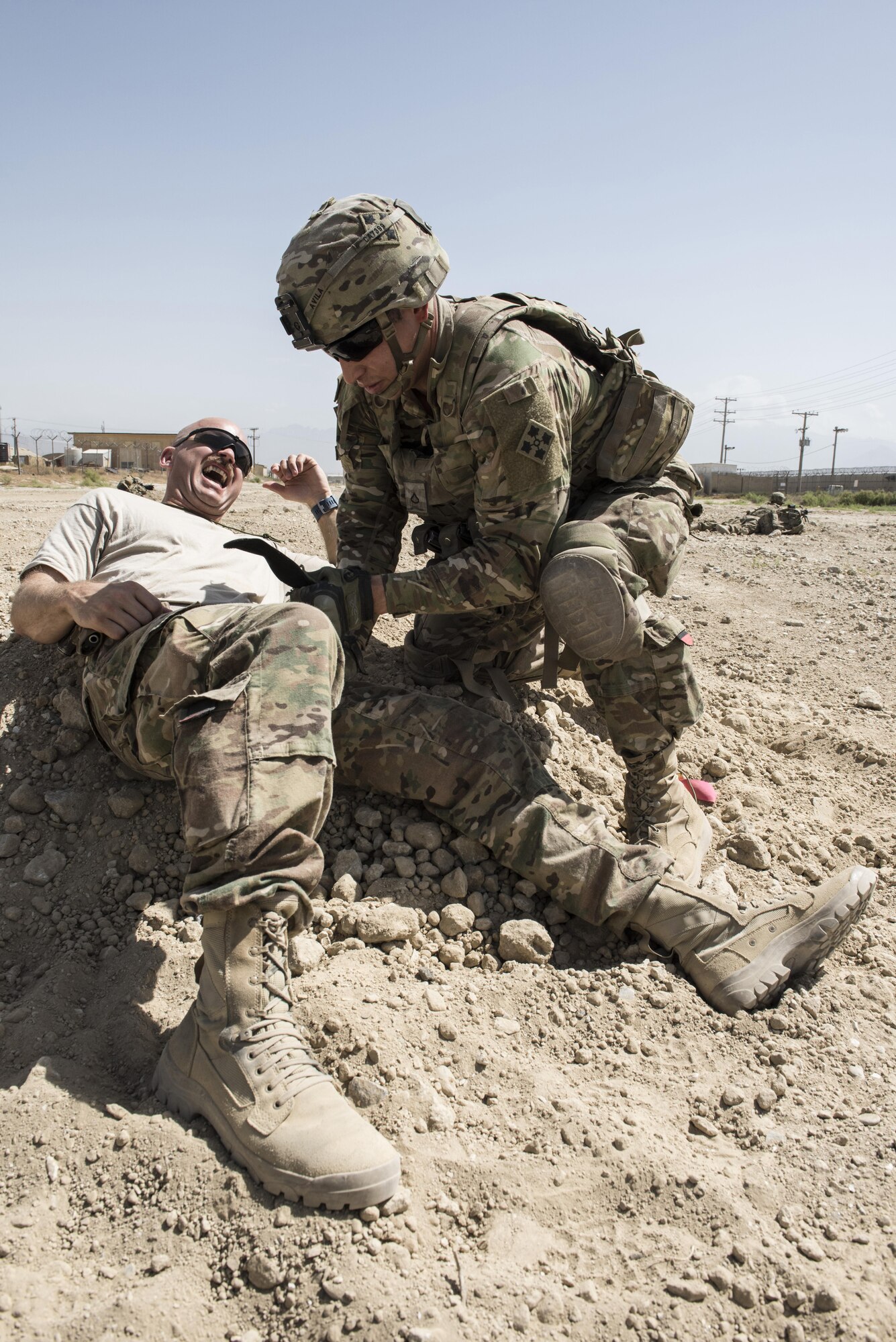 A U.S. Army soldier with Task Force Chosen, places a tourniquet on Capt. Joshua Nichols, 455th Air Expeditionary Wing military attorney, during a joint mass casualty and extraction exercise with Airmen from the 83rd Expeditionary Rescue Squadron. During the exercise scenario, the teams treated and extracted the wounded from damaged and burning vehicles. (U.S. Air Force photo by Tech. Sgt. Tyrona Lawson).