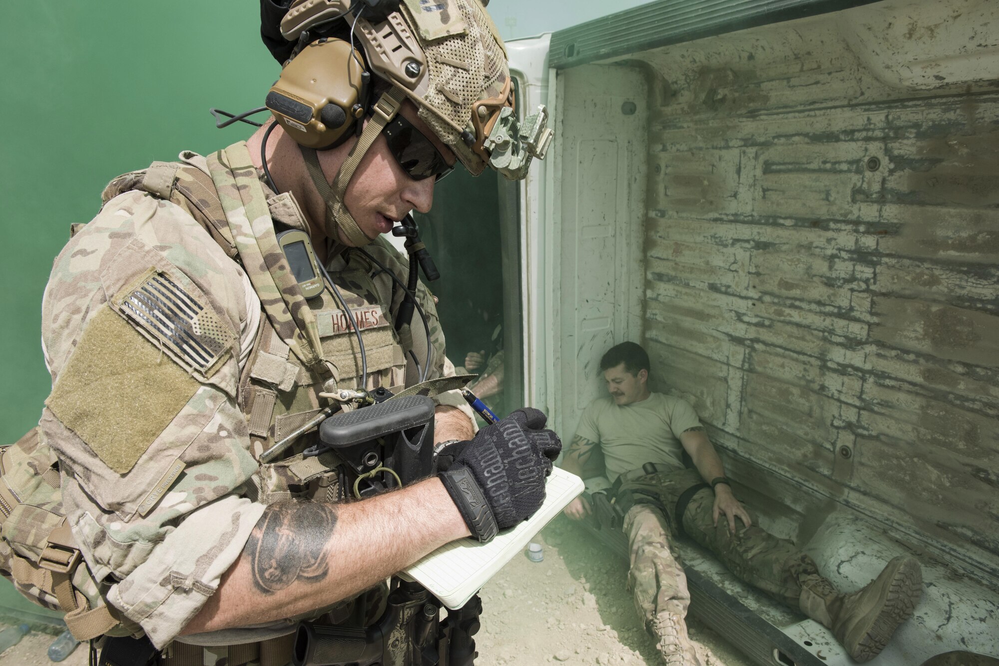 Senior Airman Travis Holmes, 83rd Expeditionary Rescue Squadron pararescue specialist, assess the scene and annotates the wounded, during a joint mass casualty and extraction exercise, June 16, 2016 at Bagram Airfield, Afghanistan. Airmen from the 83rd ERQS, paired with soldiers from Task Force Chosen to increase interoperability with each other and demonstrate theater personnel recovery capabilities. (U.S. Air Force photo by Tech. Sgt. Tyrona Lawson)