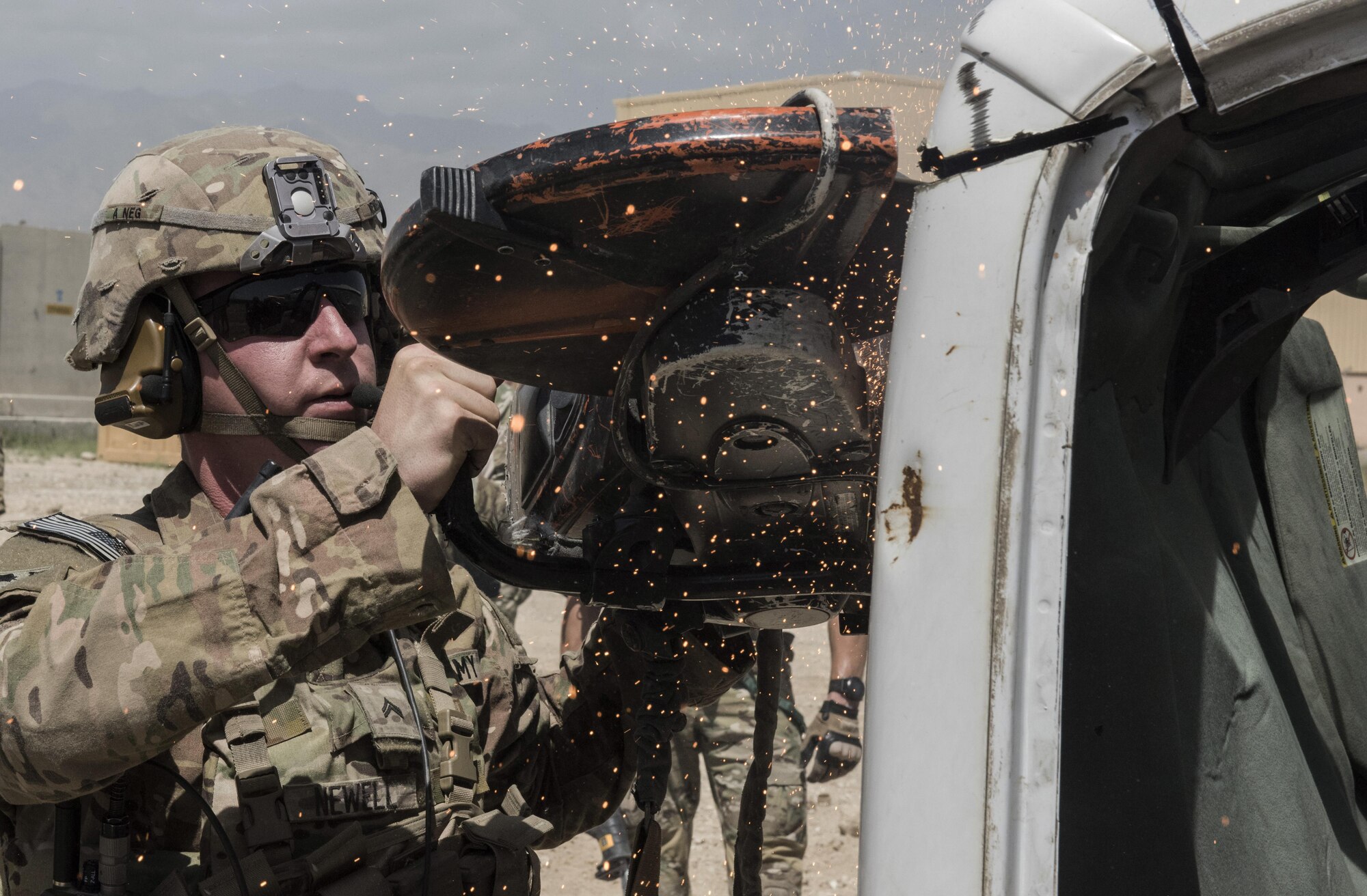 A U.S. Army soldier with Task Force Chosen, cuts the hood of a van during a joint mass casualty and extraction exercise, June 16, 2016 at Bagram Airfield, Afghanistan. Task Force Chosen paired with the 83rd Expeditionary Rescue Squadron to increase interoperability with each other and demonstrate theater personnel recovery capabilities. (U.S. Air Force photo by Tech. Sgt. Tyrona Lawson)