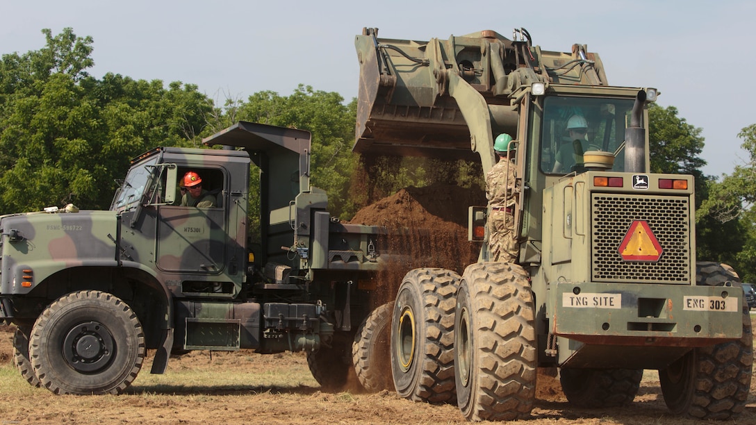 Marines with Company C, 6th Engineer Support Battalion, 4th Marine Logistics Group, Marine Forces Reserve, clear dirt from a parking lot construction site with help of commandos with 131 Commando Squadron Royal Engineers, British army, during exercise Red Dagger at Fort Indiantown Gap, Penn., June 11, 2016. As part of the exercise, the Marines and British commandos worked on various renovation and construction projects around the Army base. Exercise Red Dagger is a bilateral training exercise that gives Marines an opportunity to exchange tactics, techniques and procedures as well as build working relationships with their British counterparts.