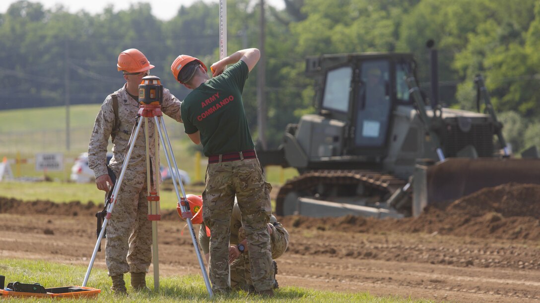 Sgt. Caleb M. Krieg (left), a squad leader with Company C, 6th Engineer Support Battalion, 4th Marine Logistics Group, Marine Forces Reserve, assists commandos with 131 Commando Squadron Royal Engineers, British army, as they survey a parking lot construction site during exercise Red Dagger at Fort Indiantown Gap, Penn., June 11, 2016. As part of the exercise, the Marines and British commandos worked on various renovation and construction projects around the Army base. Exercise Red Dagger is a bilateral training exercise that gives Marines an opportunity to exchange tactics, techniques and procedures as well as build working relationships with their British counterparts. 