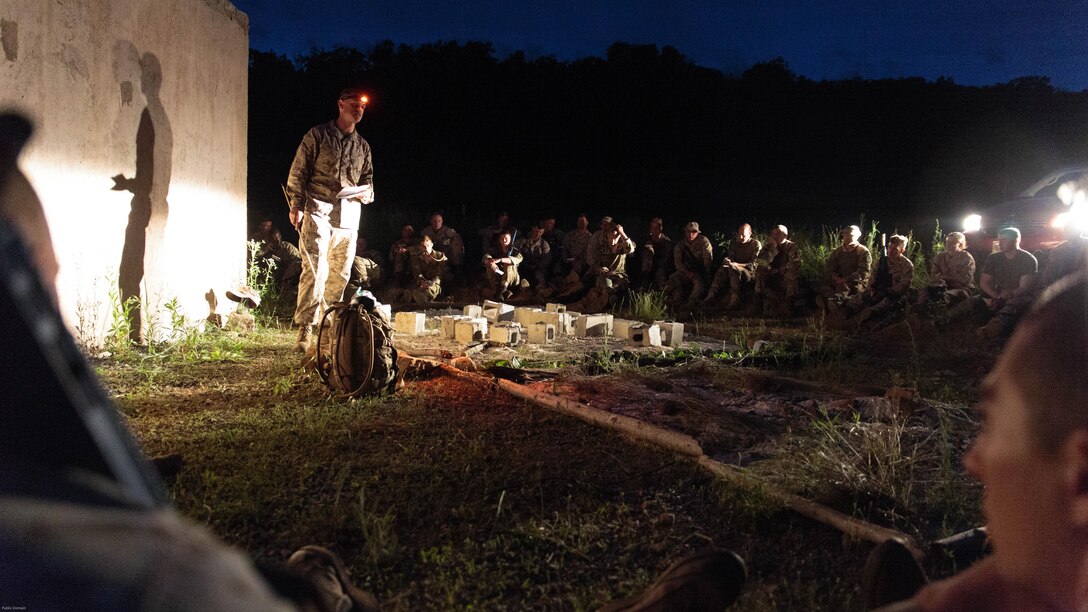 Marines with Company C, 6th Engineer Support Battalion, 4th Marine Logistics Group, Marine Forces Reserve, and commandos with 131 Commando Squadron Royal Engineers, British army, receive a mission briefing before a simulated night time raid on an urban compound during exercise Red Dagger at Fort Indiantown Gap, Penn., June 13, 2016. Exercise Red Dagger is a bilateral training exercise that gives Marines an opportunity to exchange tactics, techniques and procedures as well as build working relationships with their British counterparts.