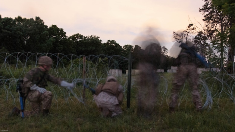 A team of combat engineers with Company C, 6th Engineer Support Battalion, 4th Marine Logistics Group, Marine Forces Reserve, and commandos with 131 Commando Squadron Royal Engineers, British army, breach a defensive obstacle during a simulated raid on an urban compound during exercise Red Dagger at Fort Indiantown Gap, Penn., June 13, 2016. Combat engineers enhance a force’s momentum by physically shaping the battle space to enhance a unit’s use of space and time while denying the enemy unencumbered movement. Red Dagger is a bilateral training exercise that gives Marines an opportunity to exchange tactics, techniques and procedures as well as build working relationships with their British counterparts. 