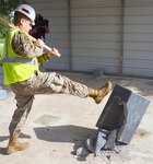 Sgt. Robert Puente, radiology specialist at the San Antonio Military Medical Center at Fort Sam Houston, helps kick the tobacco habit June 1 to signify Brooke Army Medical
Center's final step toward becoming a tobacco-free campus with a sledgehammer weilding butt-can-smashing removal of the last standing smoke shack.