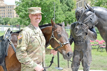 Maj. Troy D. Creason, assistant to the chief, U.S. Army Veterinary Corps, poses with Bainbridge from the Fort Sam Houston Caisson Section. Creason and Bainbridge served as the models for the Soldier and the horse depicted in the new U.S. Army Veterinary Corps monument unveiled at the U.S. Army Medical Department Museum at JBSA-Fort Sam Houston June 3. Bainbridge was named in honor of former Sgt. Maj. of the Army William G. Bainbridge. The Fort Sam Houston Caisson Section has a
tradition of naming their horses after former sergeants major of the Army.