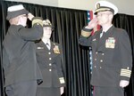 Capt. Brent M. Kelln (right) relieves Capt. Denise L. Smith (left) from command of Navy Medicine Training Support Center as the officiating officer, Rear Adm. Rebecca J. McCormick-Boyle (center), commander of Navy Medicine Education and Training Command, looks on. Kelln relieved Smith during a change of command ceremony at the Medical Education and Training Campus at Joint Base San Antonio-Fort Sam Houston Friday.