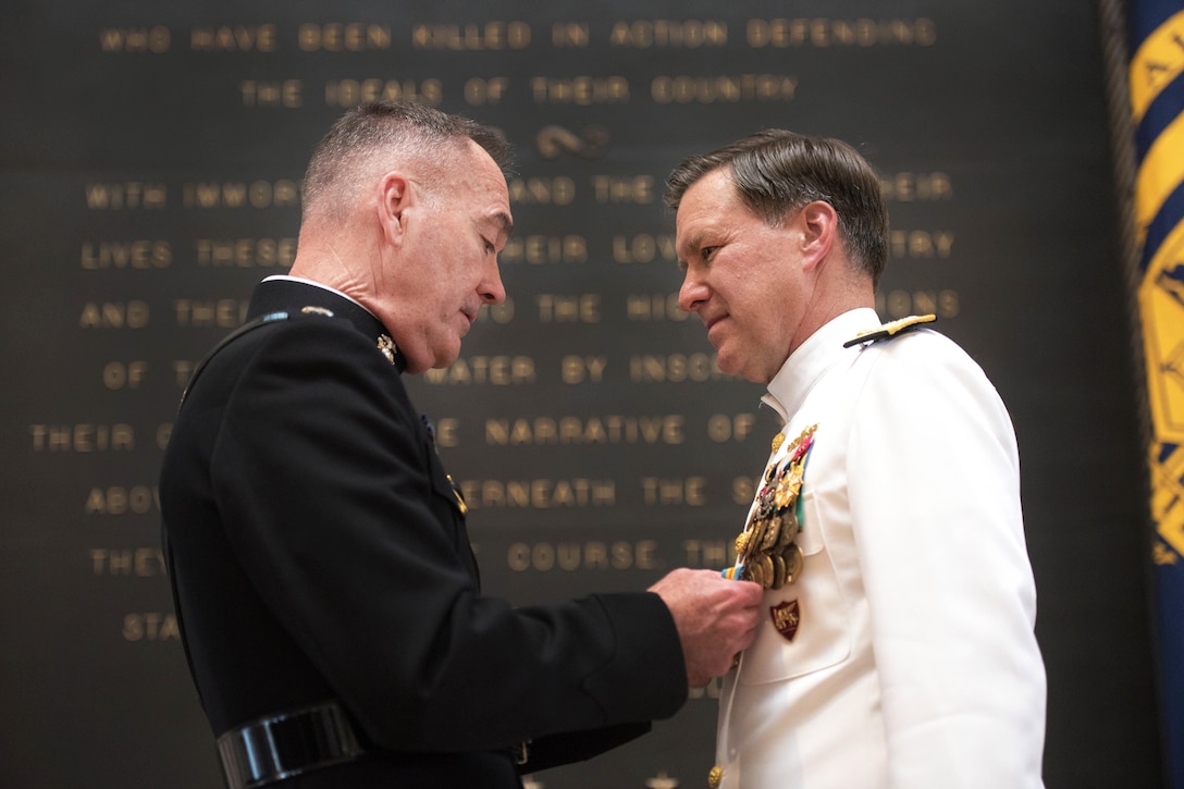 Marine Corps Gen. Joe Dunford, chairman of the Joint Chiefs of Staff, presents a retirement award to Navy Adm. Mark E. Ferguson at the U.S. Naval Academy in Annapolis, Md., June 16, 2016. DoD photo by Navy Petty Officer 2nd Class Dominique A. Pineiro