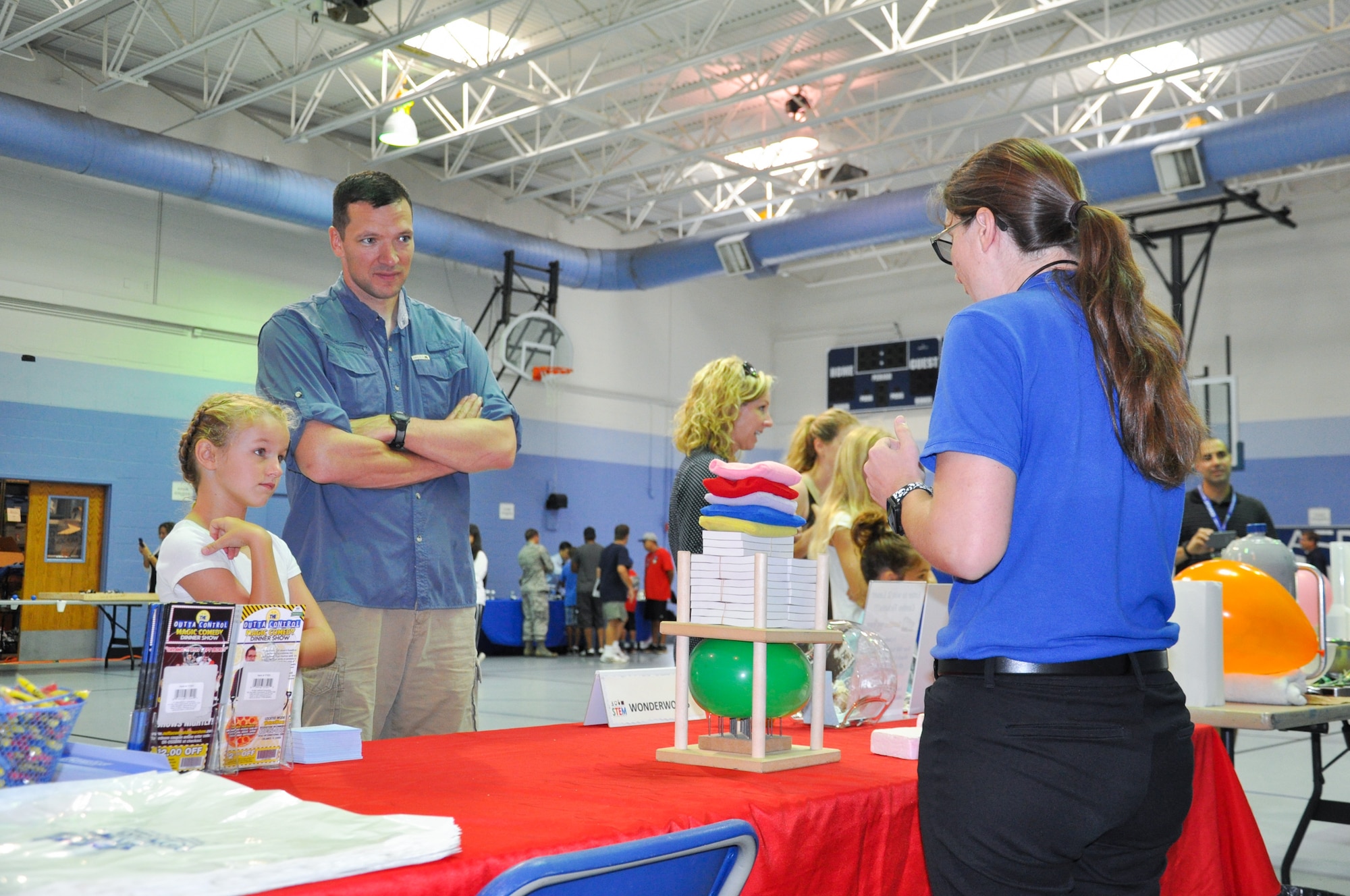 Maj. John A. Carter, 45th Logistics Readiness Squadron commander, and his daughter Emma, 8, watch a Wonderworks demonstration during the 45th Space Wing’s All SySTEMs Go event June 11, 2016, at the Youth Center/Shark Center at Patrick Air Force Base, Fla. The event was designed to teach children of all ages about science, technology, engineering and math. (U.S. Air Force Photo/Tech. Sgt. Erin Smith/Released)