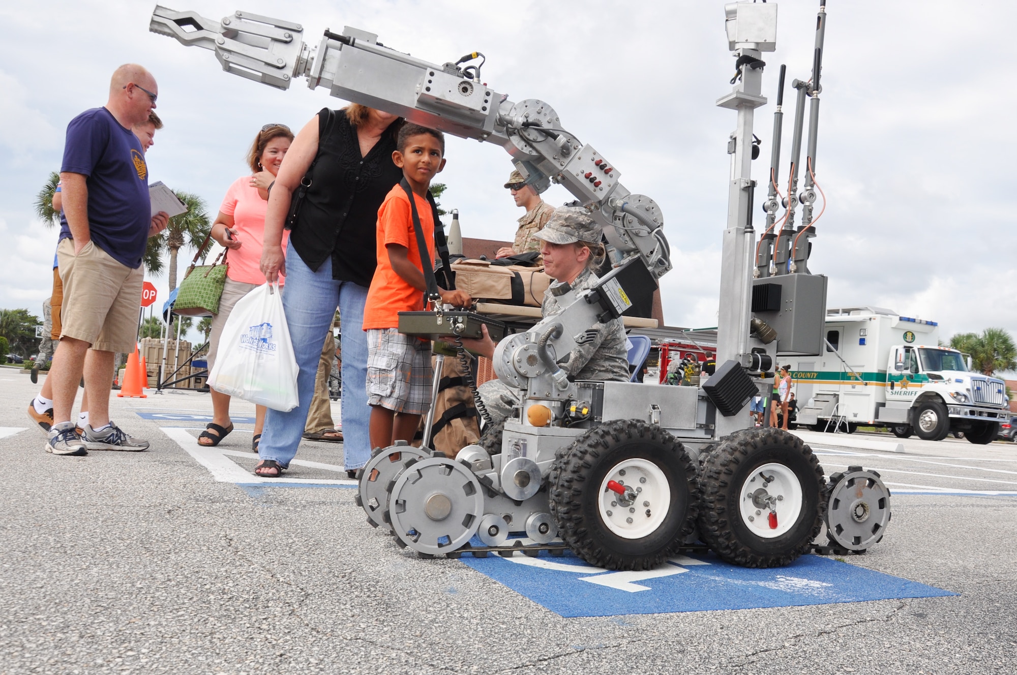 Staff Sgt. Amanda Ponce, 45th Civil Engineer Squadron Explosive Ordnance Disposal technician, teaches Josiah, 6, about the EOD’s F-6 Alpha reconnaissance robot during the 45th Space Wing’s All SySTEMs Go event June 11, 2016, at the Youth Center/Shark Center at Patrick Air Force Base. The robot is used by EOD members to neutralize explosives. (U.S. Air Force Photo/Tech. Sgt. Erin Smith/Released)