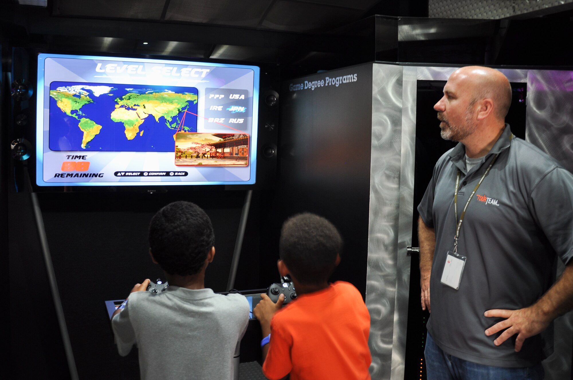 Joel Pickering teaches children about the importance of math as they play a video game created by student computer programmers from Full Sail University during the 45th Space Wing’s All SySTEMs Go event June 11, 2016, at the Youth Center/Shark Center at Patrick Air Force Base, Fla. The event was designed to teach children of all ages about science, technology, engineering and math. (U.S. Air Force Photo/Tech. Sgt. Erin Smith/Released)
