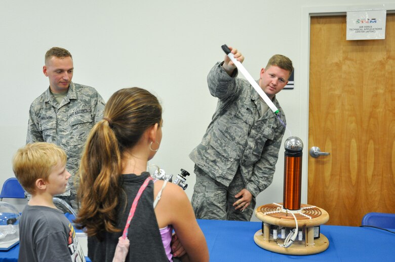Staff Sgt. Richard Westra, a geophysical equipment maintenance technician assigned to Air Force Technical Applications Center demonstrates electricity using a Tesla Coil during the 45th Space Wing’s All SySTEMs Go event June 11, 2016, at the Youth Center/Shark Center at Patrick Air Force Base. The event was designed to teach children of all ages about science, technology, engineering and math. (U.S. Air Force Photo/Tech. Sgt. Erin Smith/Released)