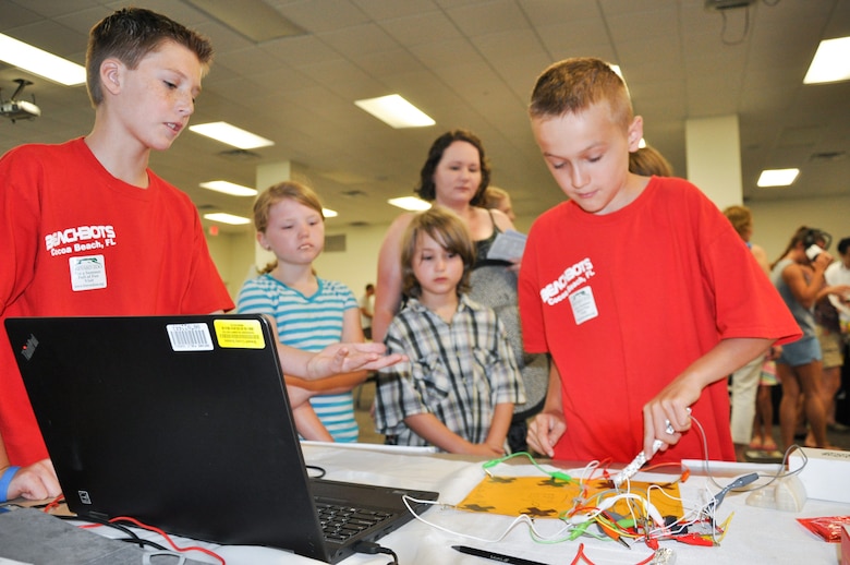 Zain, 11, and Andrew, 10, teach children to use a piano they created using Scratch software, a software program, and a Makey Makey kit, an electronic invention tool that allows users to connect everyday objects to computer programs during the 45th Space Wing’s All SySTEMs Go event June 11, 2016, at the Youth Center/Shark Center at Patrick Air Force Base, Fla. Both boys have about 1.5 years in the robotics program at their school, and demonstrated their latest invention at the event, designed to teach children of all ages about science, technology, engineering and math. (U.S. Air Force Photo/Tech. Sgt. Erin Smith/Released)
