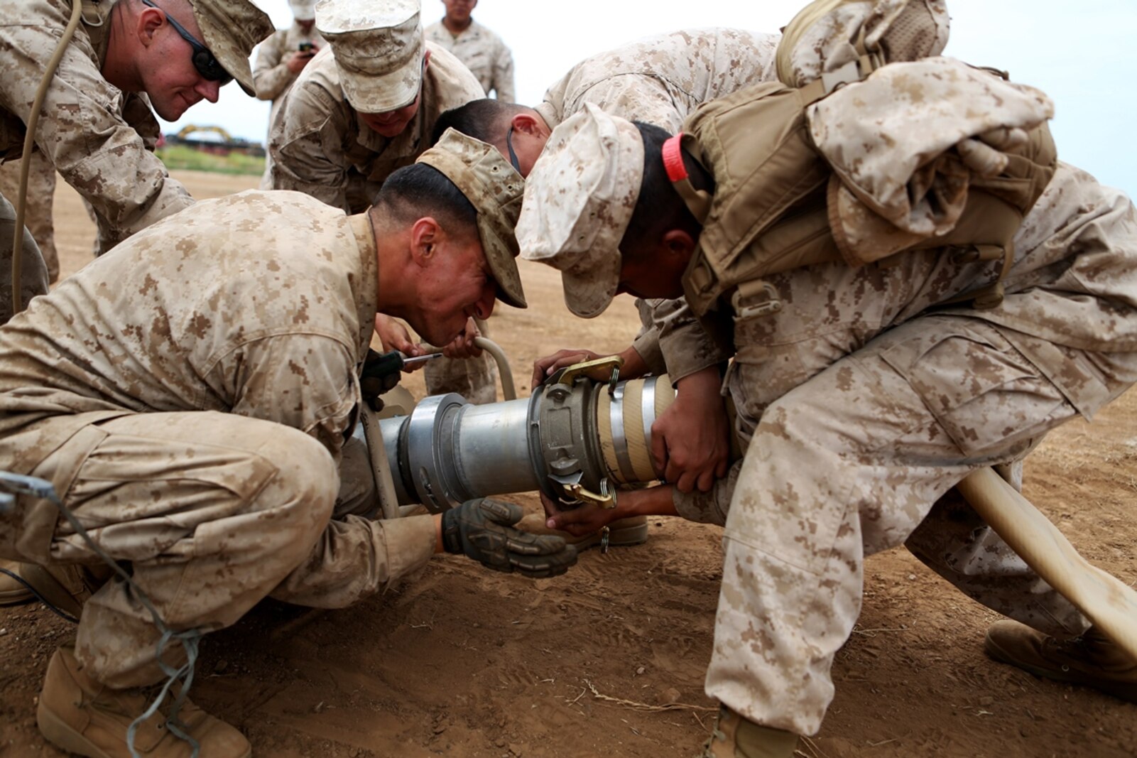 Bulk fuel and water purification Marines from 6th Engineer Support Battalion, 4th Marine Logistics Group, use an extension to make a connection between two four-inch discharge hoses during an annual training exercise aboard Camp Pendleton, Calif., June 13, 2016 to increase readiness and fulfill their yearly requirements as a reserve unit. 7th ESB, 1st Marine Logistics Group, supported their reserve counterparts with the gear necessary to pump water nearly 3 miles from the ocean at Red Beach to a training area where they practiced setting up and maintaining massive stores of water. (U.S. Marine Corps photo by Sgt. Carson Gramley/released)