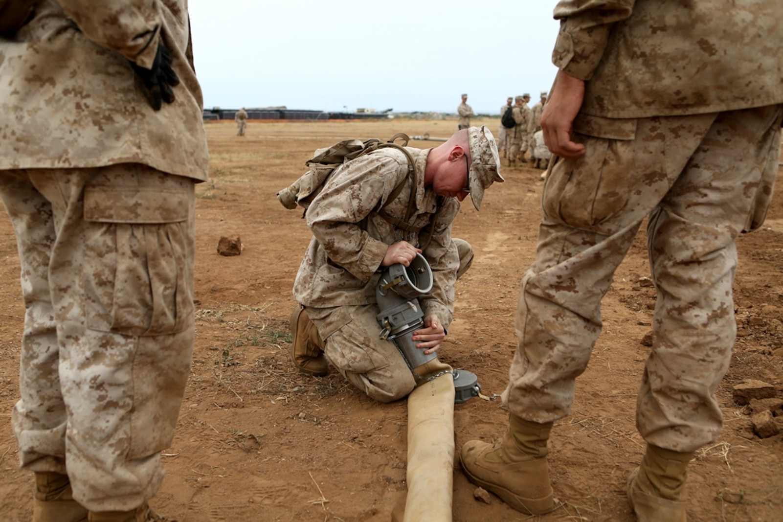 U.S. Marine Lance Cpl. Josh Allen affixes a connecting elbow to a four-inch discharge hose during an annual training exercise aboard Camp Pendleton, Calif., June 13, 2016 to increase readiness and fulfill yearly requirements as a reserve unit. Allen is a water purification specialist with Engineer Support Company, 6th Engineer Support Battalion, 4th Marine Logistics Group. 7th ESB supported their reserve counterparts with the gear necessary to pump water nearly 3 miles from the ocean at Red Beach to a training area where they practiced setting up and maintaining massive stores of water. (U.S. Marine Corps photo by Sgt. Carson Gramley/released)