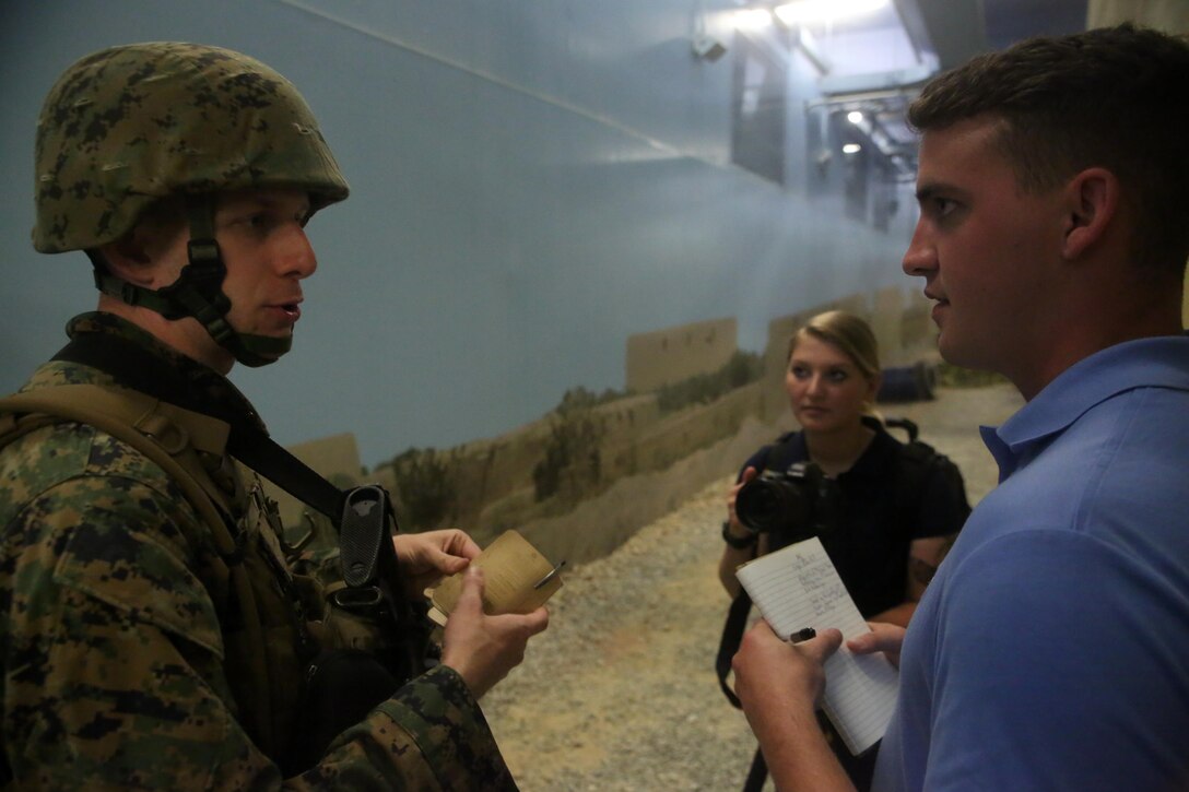 A Marine with 2nd Civil Affairs Group is notionally interviewed in a West African village during a training exercise that integrated Marines from 2nd CAG and II Marine Expeditionary Force at Camp Lejeune, N.C., June 12, 2016. The training was designed to have the civil affairs specialists assess the damages and needs of villagers in a war-torn environment. (U.S. Marine Corps photo by Cpl. Joey Mendez/Released)