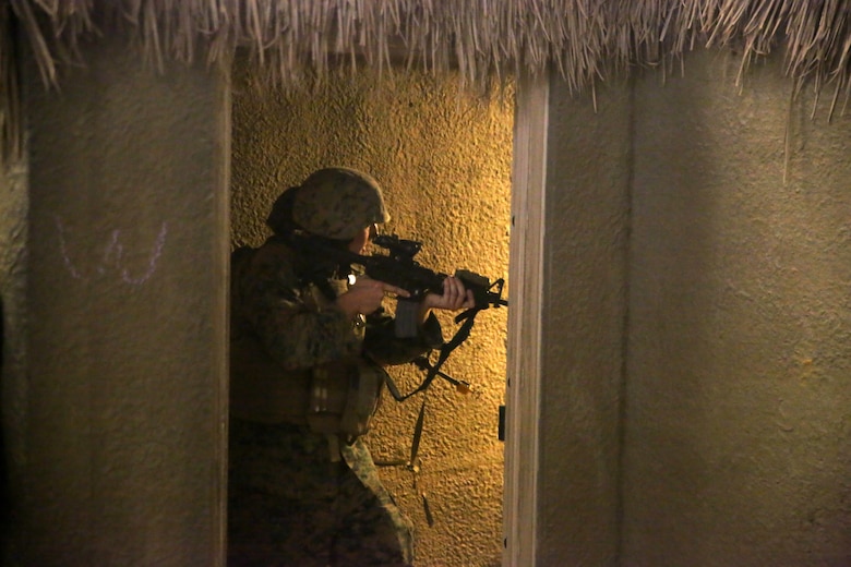 Marines with 2nd Civil Affairs Group clear a room in a notional West African village during a training exercise that integrated Marines from 2nd CAG and II Marine Expeditionary Force Camp Lejeune, N.C., June 12, 2016.  The training was designed to have the civil affairs specialists assess the damages and needs of villagers in a war-torn environment. (U.S. Marine Corps photo by Cpl. Joey Mendez/Released)