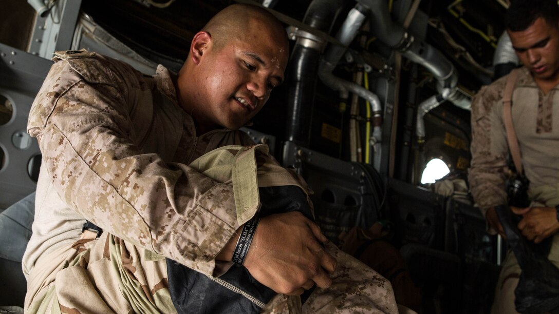 U.S. Marine Corps Staff Sgt. Steven Habon, platoon sergeant, Weapons Platoon, Fox Company, 2nd Battalion, 7th Marine Regiment, Special Purpose Marine Air-Ground Task Force-Crisis Response-Central Command 16.2, dons his gear during Chemical, Biological, Radiological and Nuclear Defense Training at an undisclosed location in Southwest Asia, May 03, 2016. SPMAGTF-CR-CC is forward deployed in several host nations, with the ability to respond to a variety of contingencies rapidly and effectively. 