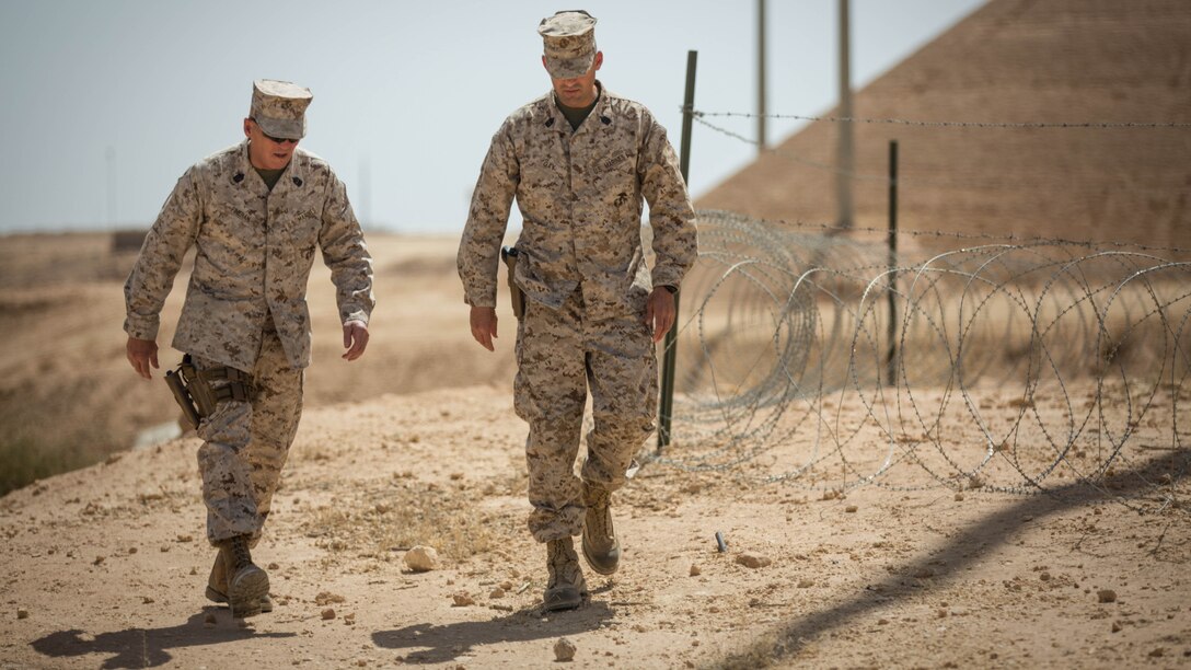 U.S. Marine Corps Sgt. Maj. Lawrence Fineran (left), sergeant major of Marine Corps Forces Central Command, tours Al Asad Air Base, Iraq, with 1st Sgt. Adrian Gay, senior enlisted advisor for Task Force Al Asad, May 23, 2016. Advise and assist sites like Al Asad Air Base are an integral part of Combined Joint Task Force - Operation Inherent Resolve’s multinational effort to increase the military capacity of Iraqi Security Force personnel to defeat the Islamic State of Iraq and the Levant. 