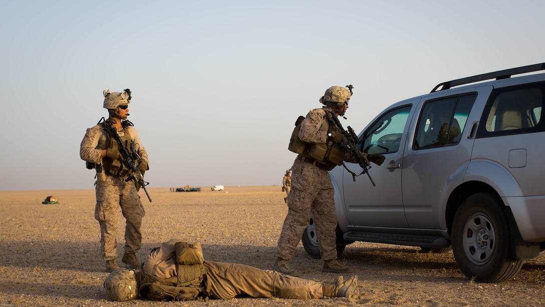 U.S. Marines with 2nd Battalion, 7th Marine Regiment, Special Purpose Marine Air Ground Task Force - Crisis Response - Central Command, speak with simulated casualties during a Tactical Recovery of Aircraft and Personnel exercise at an undisclosed location in Southwest Asia, May 23, 2016. SPMAGTF-CR-CC is ready to respond to any crisis response mission in theater to include the employment of a TRAP force. 