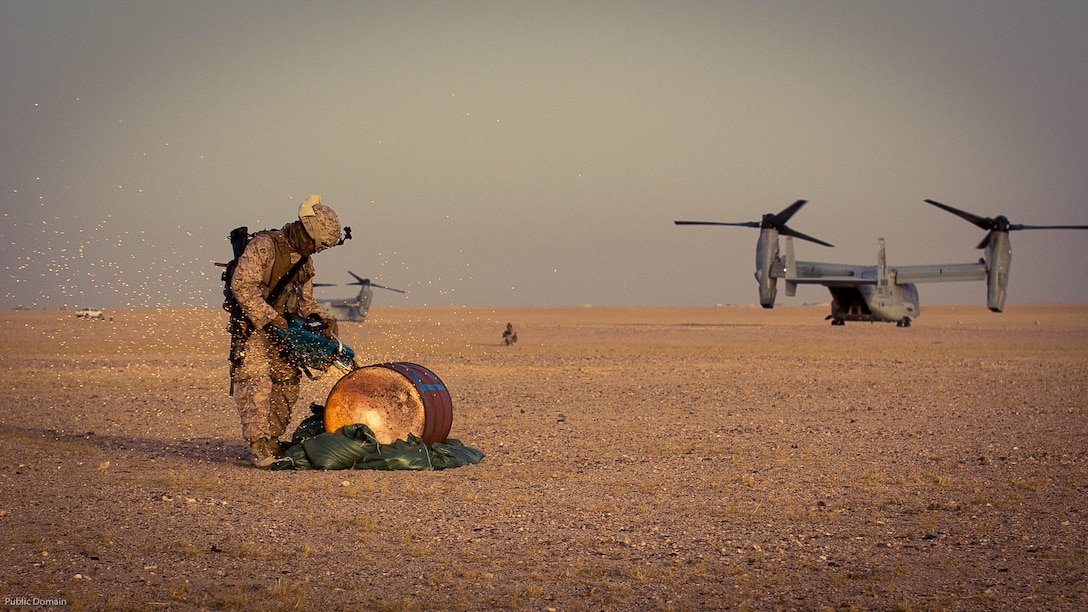U.S. Marine Corps Lance Cpl. Adrian Santoyosolorzano, a rescue firefighter with Marine Wing Support Squadron 373, Special Purpose Marine Air Ground Task Force - Crisis Response - Central Command, cuts through a barrel during a Tactical Recovery of Aircraft and Personnel exercise at an undisclosed location in Southwest Asia, May 23, 2016. SPMAGTF-CR-CC is ready to respond to any crisis response mission in theater to include the employment of a TRAP force.