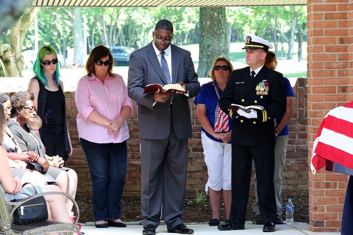 Bill Jones (center), project officer for Combat Equipment Support Systems at Marine Corps Systems Command, welcomes attendees June 7 to the funeral for Serina Vine, a World War II veteran who passed away May 21. Because Vine had no known next of kin, Jones and two other MCSC employees came together to organize her funeral, complete with full military honors. More than 200 people attended the ceremony at Quantico National Cemetery in Triangle, Virginia, thanks to the efforts of the MCSC members. (U.S. Marine Corps photo by Mathuel Browne)  