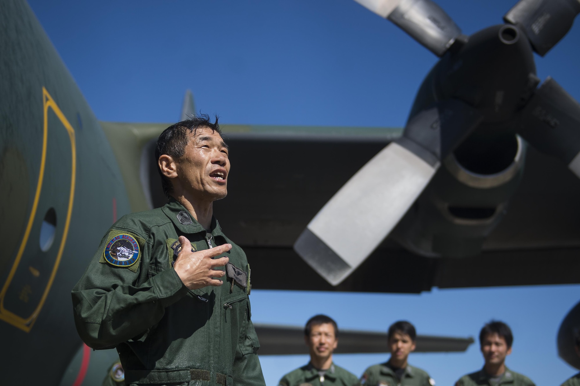 Japanese Air Self Defense Force Chief Master Sgt. Takanori Konishi, assigned to the 401st Squadron completes a milestone of 10,000 C-130 Hercules flight hours on Joint Base Elmendorf-Richardson, Alaska, June 15, 2016.    (U.S. Air Force photo by Senior Airman James Richardson)