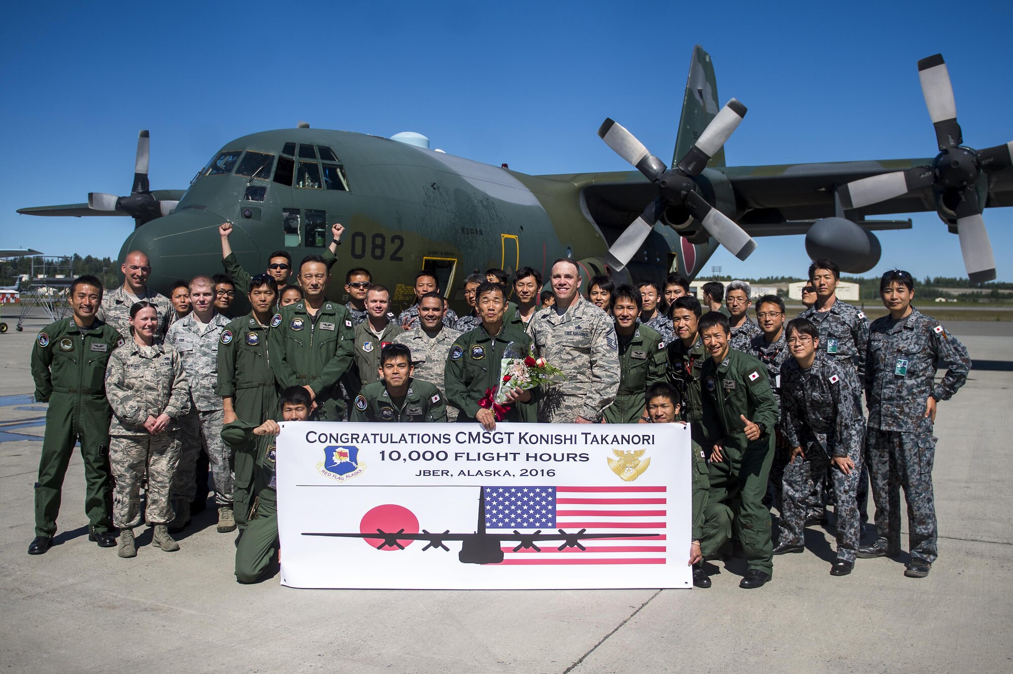 Japanese Air Self Defense Force Chief Master Sgt. Takanori Konishi, assigned to the 401st Squadron completes a milestone of 10,000 C-130 Hercules flight hours on Joint Base Elmendorf-Richardson, Alaska, June 15, 2016.    (U.S. Air Force photo by Senior Airman James Richardson)
