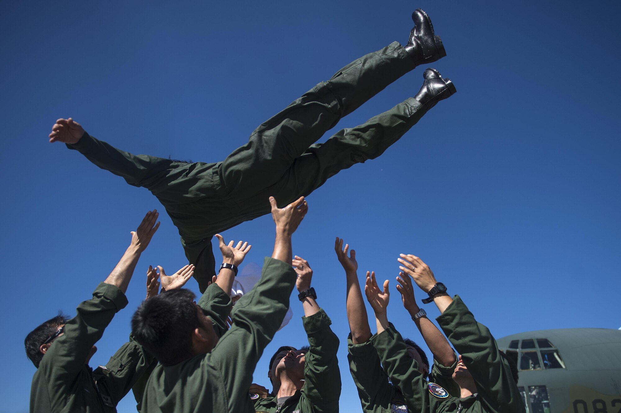 Japanese Air Self Defense Force Chief Master Sgt. Takanori Konishi, assigned to the 401st Squadron completes a milestone of 10,000 C-130 Hercules flight hours on Joint Base Elmendorf-Richardson, Alaska, June 15, 2016.    (U.S. Air Force photo by Senior Airman James Richardson)