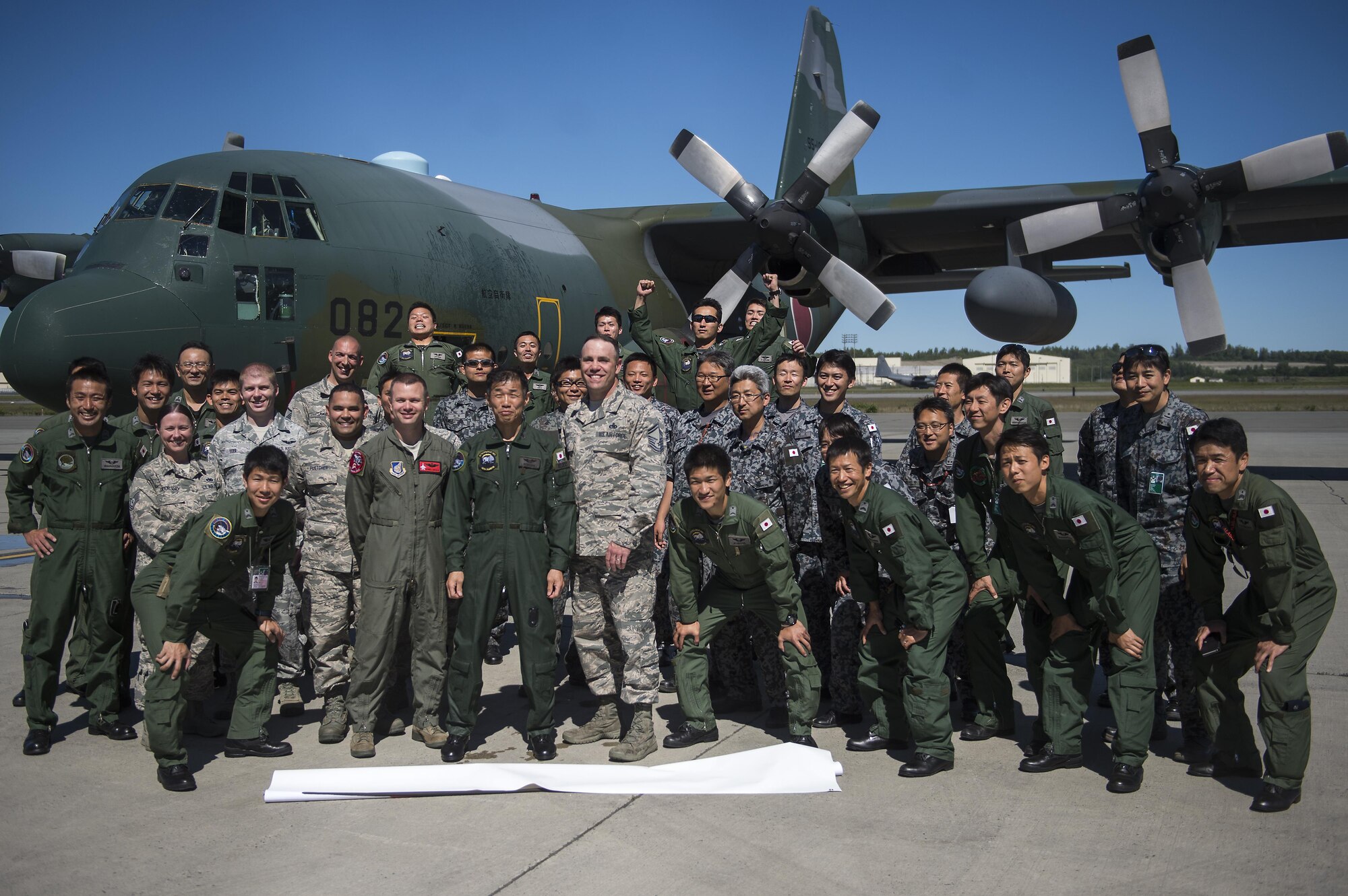 Japanese Air Defense Force Chief Master Sgt. Takanori Konishi, assigned to the 401st Squadron completes a milestone of 10,000 C-130 Hercules flight hours on Joint Base Elmendorf-Richardson, Alaska, June 15, 2016.    (U.S. Air Force photo by Senior Airman James Richardson)