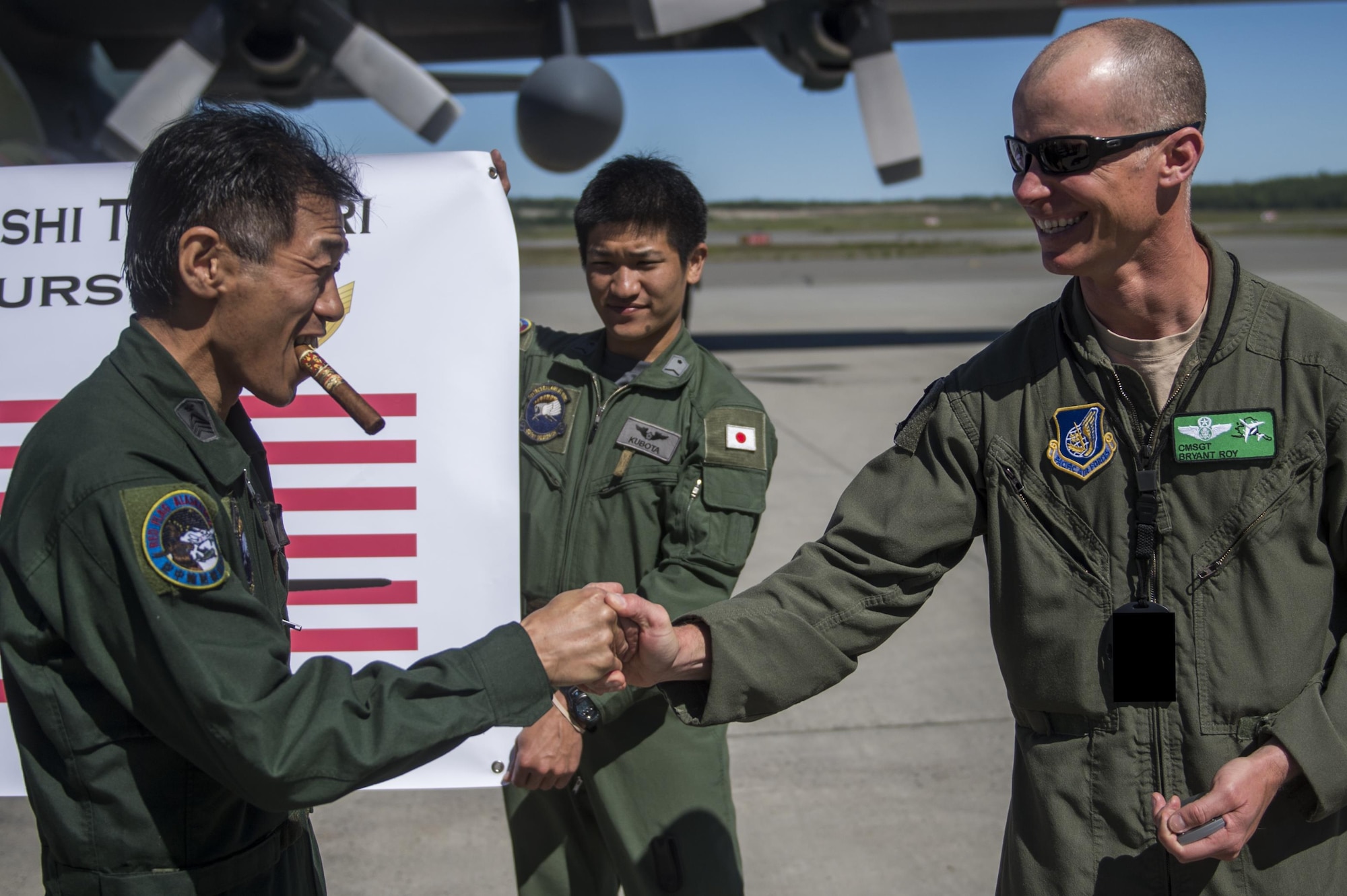 Japanese Air Self Defense Force Chief Master Sgt. Takanori Konishi, assigned to the 401st Squadron completes a milestone of 10,000 C-130 Hercules flight hours on Joint Base Elmendorf-Richardson, Alaska, June 15, 2016.    (U.S. Air Force photo by Senior Airman James Richardson)