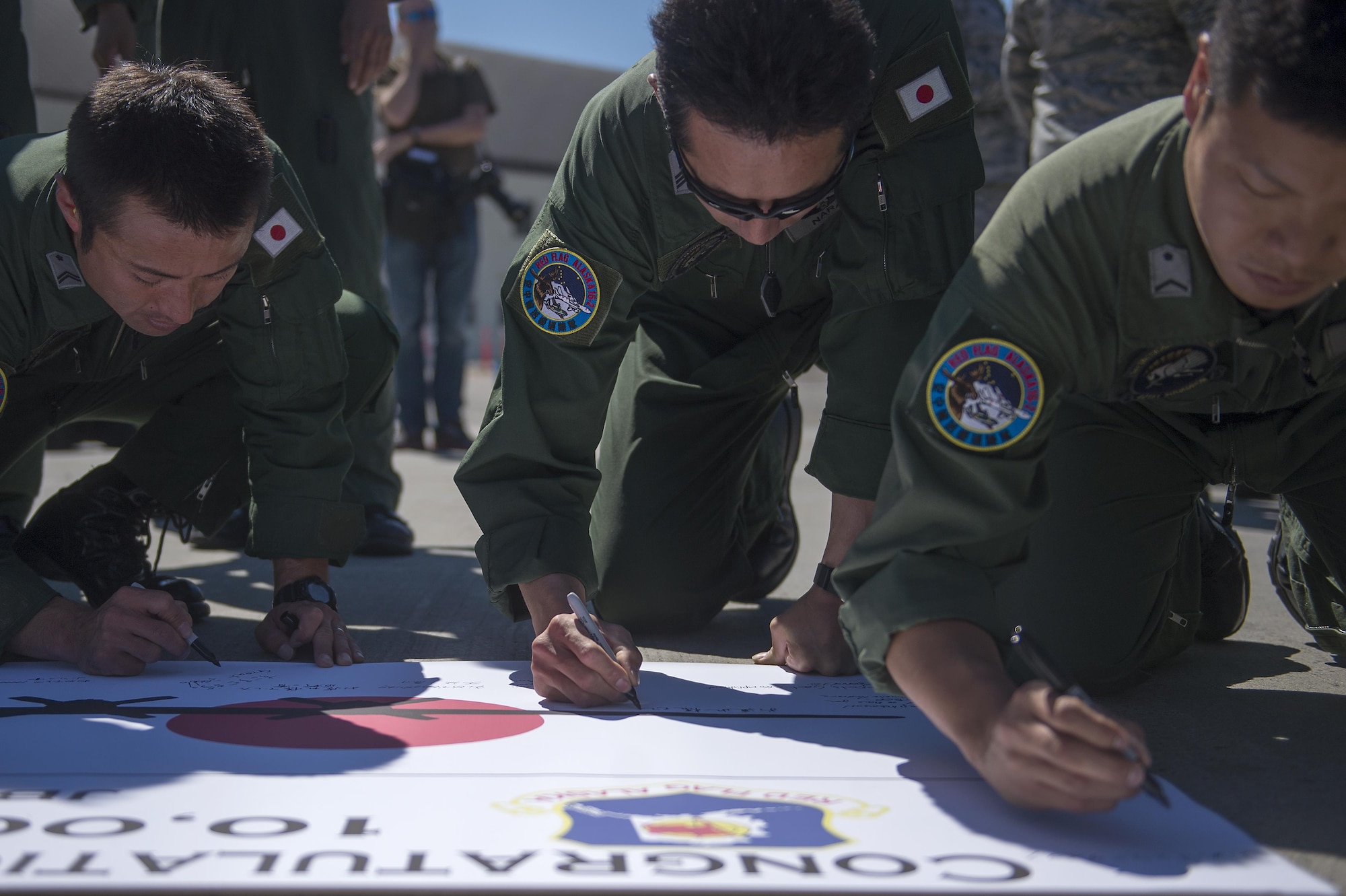 Japanese Air Self Defense Force Chief Master Sgt. Takanori Konishi, assigned to the 401st Squadron completes a milestone of 10,000 C-130 Hercules flight hours on Joint Base Elmendorf-Richardson, Alaska, June 15, 2016.    (U.S. Air Force photo by Senior Airman James Richardson)