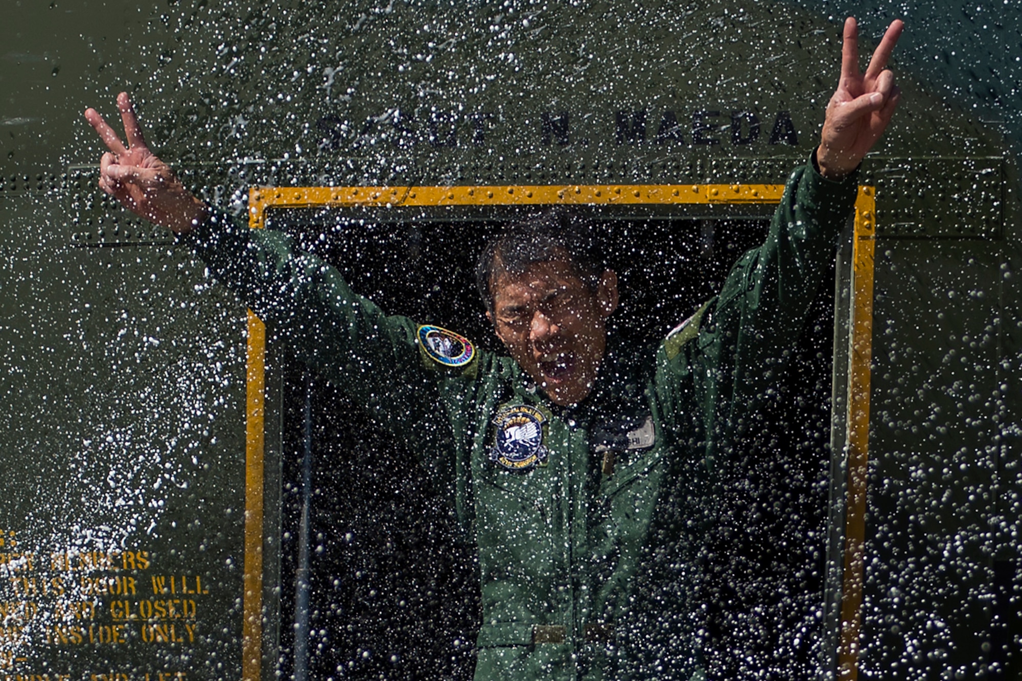 Japanese Air Self Defense Force Chief Master Sgt. Takanori Konishi, assigned to the 401st Squadron completes a milestone of 10,000 C-130 Hercules flight hours on Joint Base Elmendorf-Richardson, Alaska, June 15, 2016. (U.S. Air Force photo by Senior Airman James Richardson)